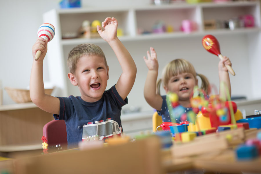 Two children playing with toys at a desk